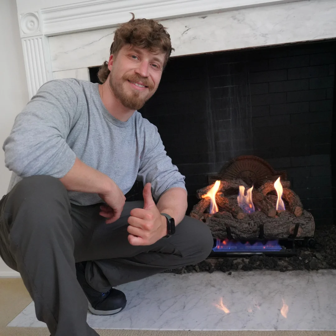 Sky Chimney Service technician finishing a gas fireplace service in Cincinnati
